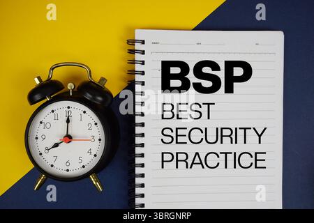 BSP Best Security Practice text written on notepad with alarm clock on yellow background Stock Photo