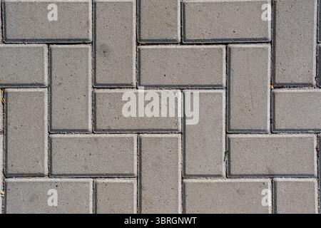 Background of a sidewalk paved with concrete block paving Stock Photo