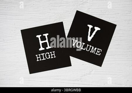 HV - High Volume text on stick note on concrete background Stock Photo