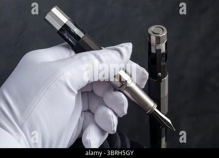 Branded pen with ink and nib in a box. Gift set. Selective focus. Office interior. Stock Photo