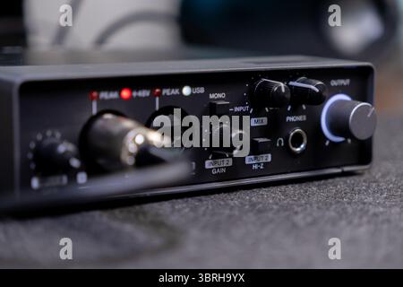 Detailed view of a professional sound card with an illuminated 48V indicator, control knobs for INPUT and MIX, supporting home recording and podcastin Stock Photo