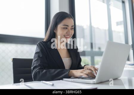 Beautiful Business Woman working by using laptop computer Hands typing on keyboard. Professional investor working new start up project. business plann Stock Photo