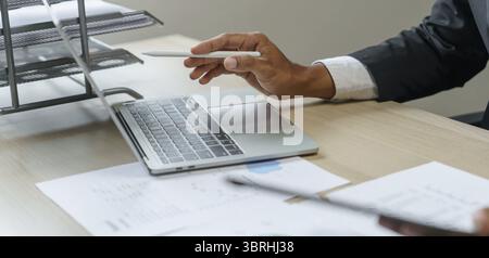 Man working by using a laptop computer Hands typing on keyboard. writing a blog. Working at home are in hand finger typewriter Stock Photo
