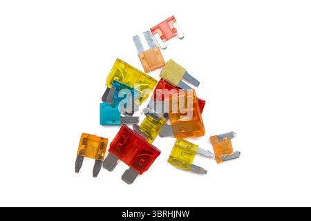 A pile of colorful blade fuses of different sizes and ratings isolated on a white background. Ideal for car repair and replacement. Stock Photo