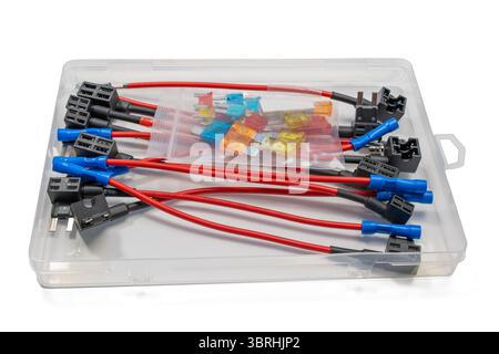 A fuse tap kit with red wires, blue connectors, and assorted blade fuses. The components are arranged in a transparent case, isolated on a white backg Stock Photo