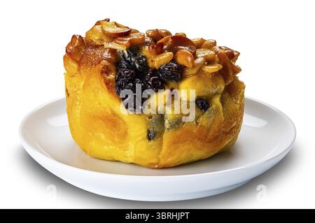Butter bun garnished with raisin and nuts in white ceramic dish isolated on white background with clipping path Stock Photo