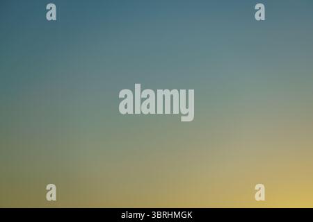 Sunrise creates a variety of gradient colors as the morning sky gradually transitions between the darkness of night to the vivid blue of a clear day. Stock Photo
