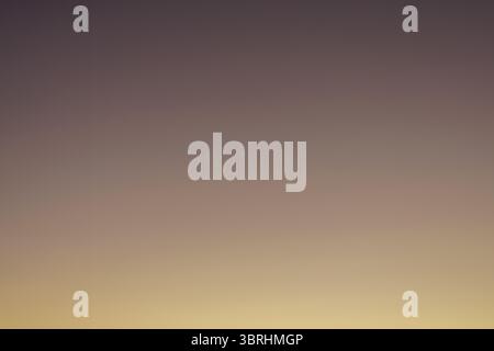 Chocolate Orange Gradient Background - Sunrise creates a variety of gradient colors int the morning sky as it gradually transitions to daylight. Stock Photo