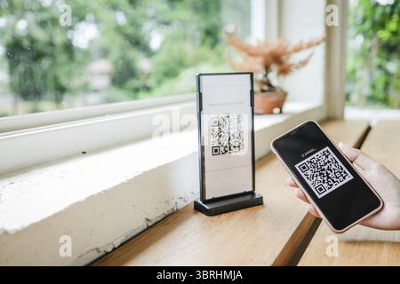 E wallet Qr code payment digital pay without money. Woman scanning QR code online shopping cashless technology concept Stock Photo
