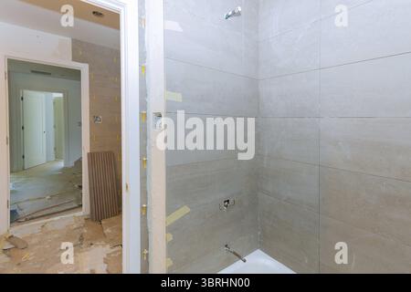 Renovation construction laying floor and wall tile unfinished reconstruction of bathroom Stock Photo