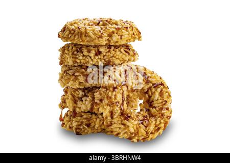 Side view tower stack of crispy homemade rice crackers with cane sugar syrup isolated on white background with clipping path, closeup Stock Photo