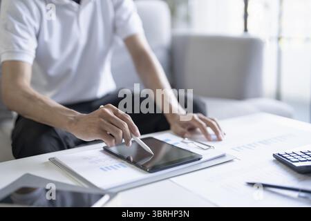 Business man working on digital tablet Graphic designer drawing on graphic tablet creative studying work at home Stock Photo