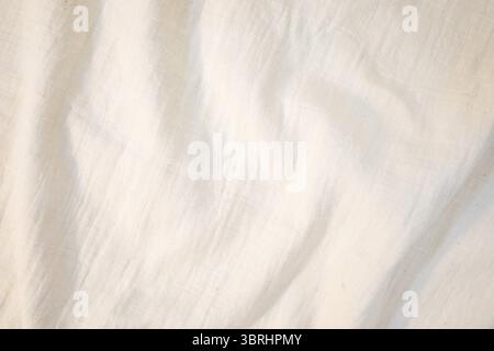 Fabric backdrop White linen canvas crumpled natural cotton fabric Natural handmade linen top view background Organic Eco textiles White Fabric linen t Stock Photo