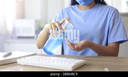 Hand applying Alcohol gel sanitazer liquid cleaning hands for prevent corona virus covid-19. woman hand sanitizer Alcohol gel gel for hand hygiene new Stock Photo