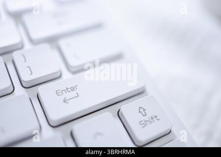 Hands of business woman Index finger pressing enter button on computer keyboard Stock Photo