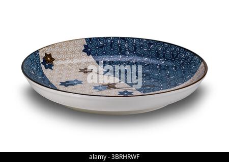 High angle view of empty blue and brown star pattern dark edge ceramic plate isolated on white background with clipping path Stock Photo