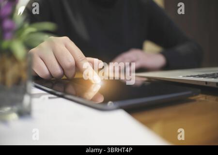 Woman hand presses on screen digital tablet Online Digital marketing technology concept Stock Photo