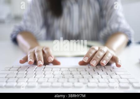 Hands typing on keyboard. writing a blog. woman hands on the keyboard Working at home. hand are in finger typewriter Stock Photo