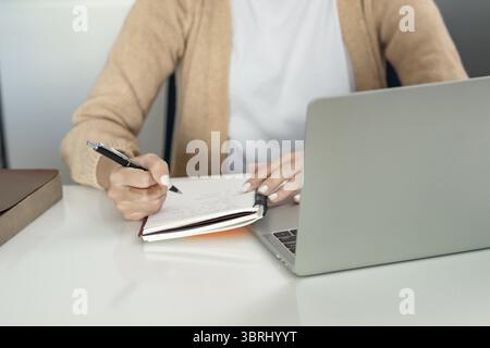 Happy young Asian Woman Successful working with laptop checking happy congrats get good news Young asian feel excited and colleague student passed exa Stock Photo