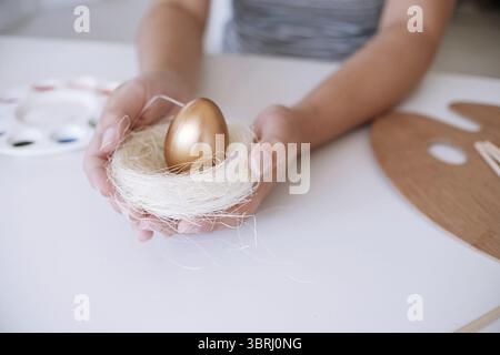 Woman painting Easter eggs at home. family preparing for Easter. Hands of a girl with a easter egg Stock Photo