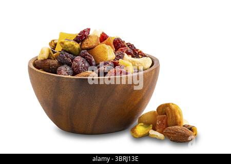 Breakfast mix nuts and fruits in wooden bowl and pile on the floor isolated on white background with clipping path Stock Photo