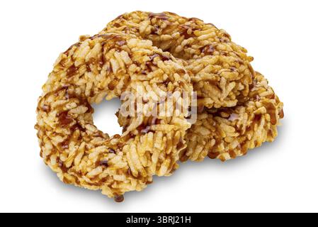 Closeup view pile of crispy homemade sweet rice crackers with cane sugar syrup isolated on white background with clipping path Stock Photo