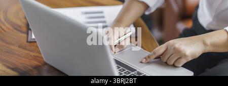Happy young Asian Woman working on computer Business Data Analyst Stock Photo