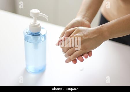 Hand applying Alcohol gel sanitazer liquid cleaning hands for prevent corona virus covid-19 Stock Photo