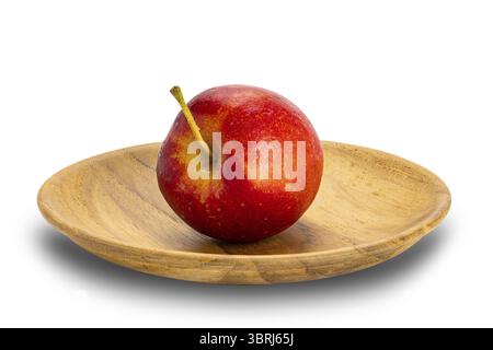 Side view of single fresh ripe crisp snack-size mini apple or little apple or small apple in wooden plate on white background with clipping path Stock Photo