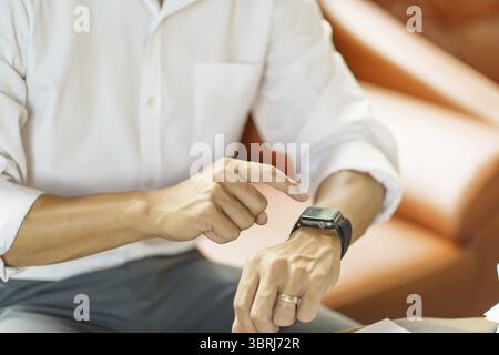 Business man Looking at smart watch In Office online connect Gadget technology Stock Photo