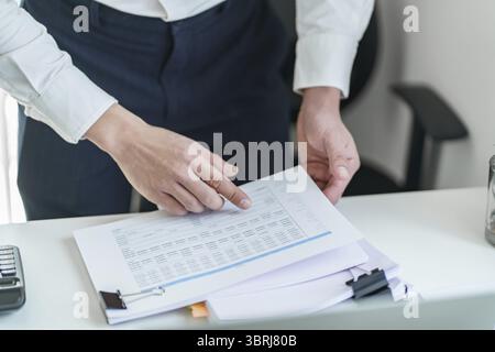 Young business man busy working at office. businessman doing financial paperwork business management concept Stock Photo
