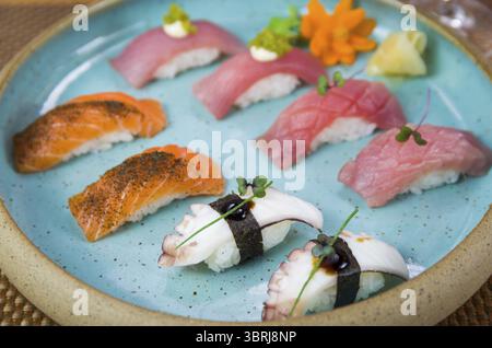 Assorted premium tuna and salmon nigiri sushi on a beautifully decorated plate Stock Photo