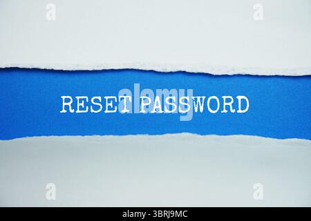 Reset Password message written on blue paper with torn paper background Stock Photo