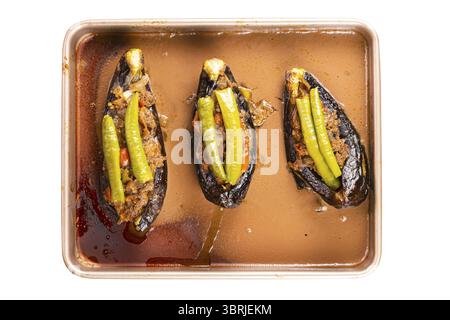 Top view of delicious homemade turkey stuffed eggplants or Karniyarik in tray metal oven on white background with clipping path Stock Photo