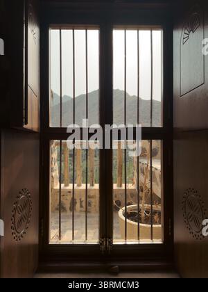 view of mountains from old wooden window with bars, holiday retreat in the mountains in UAE, rural architecture Stock Photo