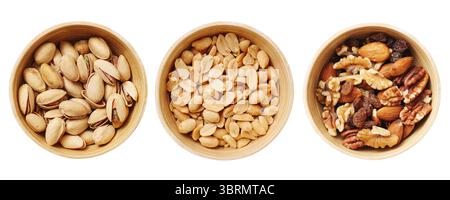 Assorted nuts in bowls. Pistachios, peanuts, and mixed nuts on white background. Healthy snack or ingredient for cooking. Vegan food rich in protein. Stock Photo