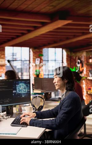 Startup senior manager leveraging artificial intelligence technology in office to gain competitive edge. Experienced Silicon Valley company AI specialist working on rapid technological advancement Stock Photo