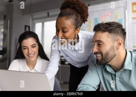 Multiracial workmates working together during meeting in office using laptop Stock Photo