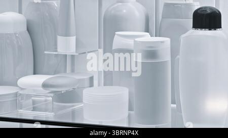 Row of  bottles and containers of various sizes and shapes are lined up on a counter. bottles are all purple and some are Stock Photo