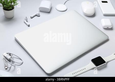 Composition with different modern gadgets on grey background Stock Photo