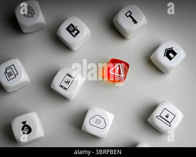 Scam alert concept. cyber security and data protection. Warning caution icon on red dice, surrounded with white dices group with equipments, digital i Stock Photo