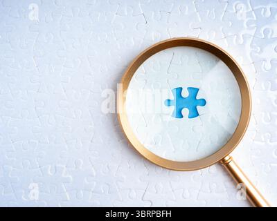 HR, human resources, recruitment and hiring, problem solving solution, business strategy concept. Blue space for last missing piece, focus in magnifyi Stock Photo
