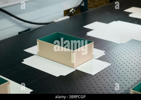 Innovative robotic gluing process in a modern box manufacturing plant enhances production efficiency and precision Stock Photo