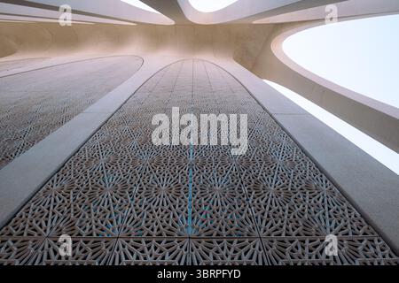 Geometric Islamic architecture with intricate patterns and large arches, viewed from below Stock Photo