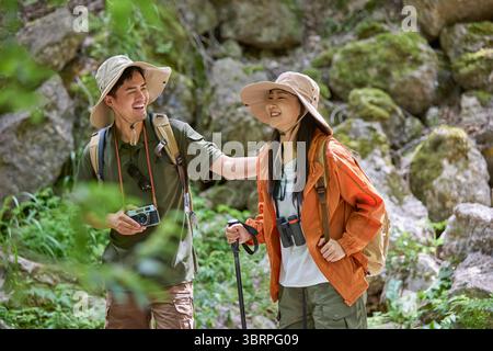 Happy man hiking through the serene beauty of nature Stock Photo