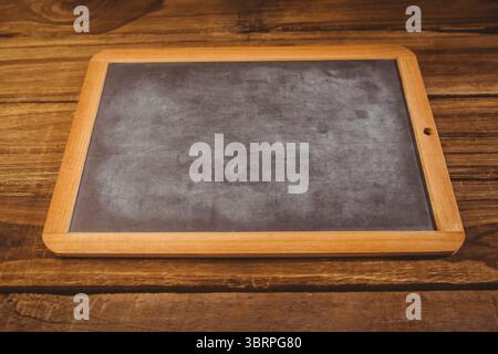 Blank rectangular chalkboard with wooden frame is lying flat on rustic wood table in flat design Stock Photo