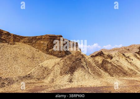 Pile with wood chips at a storage place Stock Photo