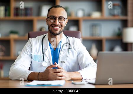 Portrait of happy arabic doctor posing at clinic Stock Photo