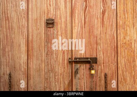 closeup of old wooden door with metal latch and lock Stock Photo