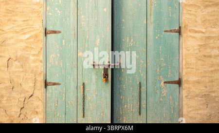 old wooden door with lock, heritage vintage aged wood rustic look door vintage lock system, cast iron hinges, space for copy text Stock Photo